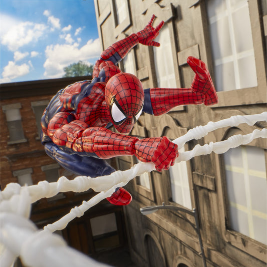 Spider-Man figure climbing a web between buildings with a clear sky background