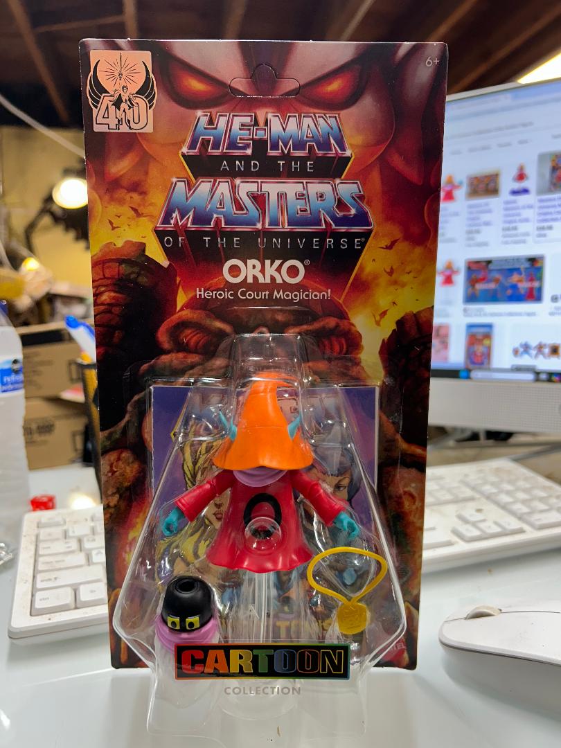 Orko figure from He-Man and the Masters of the Universe in packaging on a desk.