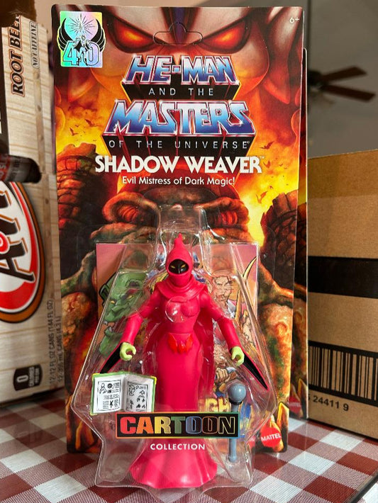 Action figure in packaging with 'He-Man and the Masters of the Universe' theme on a checkered surface.