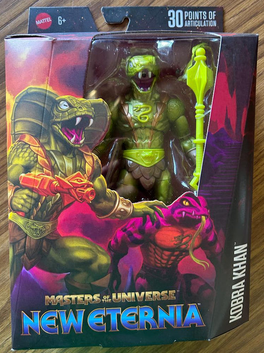 Masters of the Universe New Eternia action figure packaging on a wooden surface
