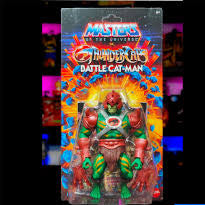 Toy figure packaging with 'Masters of the Universe' branding on a colorful background